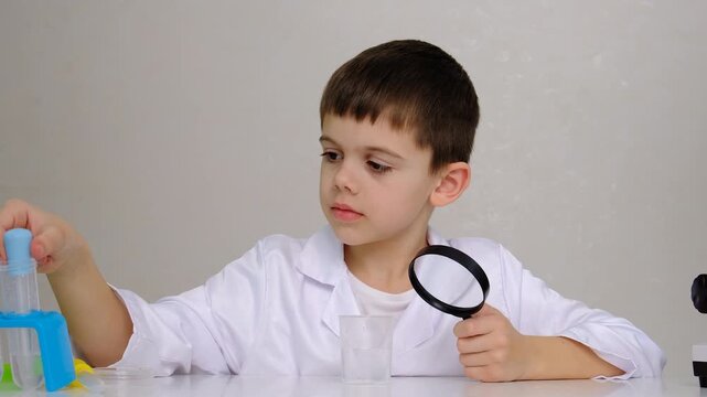Laboratory examination of a child with test tubes, reagents and a microscope. Selective focus.