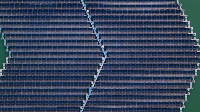 Aerial view of the floating photovoltaic system of the Rohr company with rows of solar panels on water in Bensheim, Hessen, Germany.