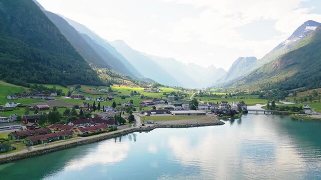 Aerial view of the village of Olden nestled between steep mountains and the turquoise waters of the Nordfjord in Olden, Vestland, Norway.