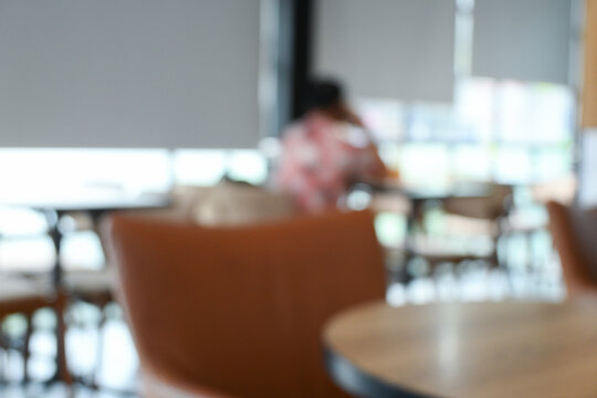 softy blurred view of a modern cafe or lounge interior featuring comfortable chair and round table