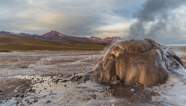 View of El Tatio geyser erupting with steam in the volcanic landscape of the Andes mountains in Antofagasta, Antofagasta, Chile.
