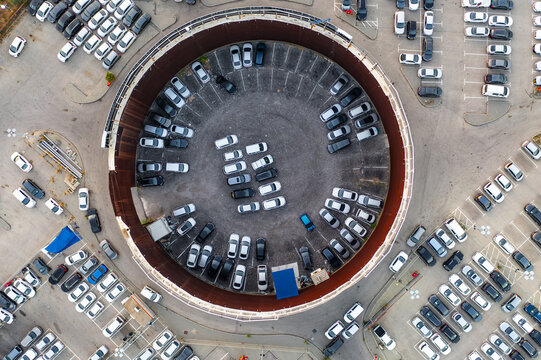 Aerial view of a circular car lot filled with parked vehicles in Ramat Hasharon, Tel Aviv District, Israel.