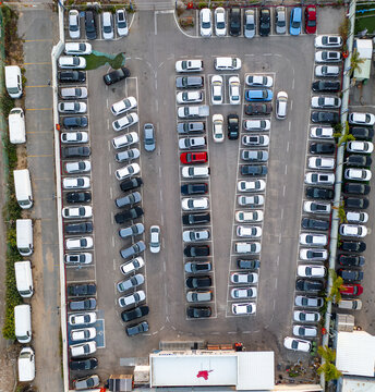 Aerial view of a car lot filled with numerous parked vehicles arranged in rows in Ramat Hasharon, Tel Aviv District, Israel.