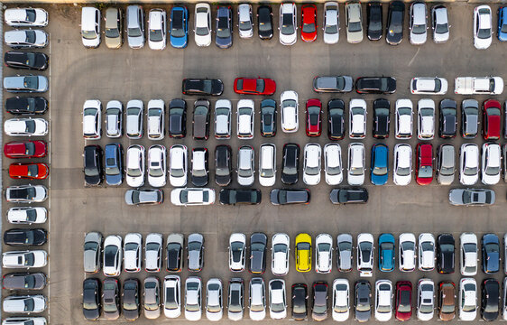 Aerial view of a car lot filled with many parked vehicles of various colors and models arranged in neat rows in Ramat Hasharon, Tel Aviv District, Israel.