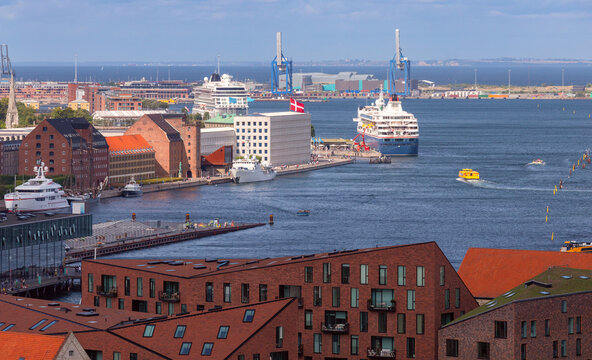 Elevated view of Copenhagen harbor with cruise ships, boats, waterfront buildings and port infrastructure in Denmark.