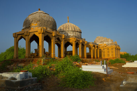 View of Chitorri Graveyard with its historic stone tombs and domes under a clear blue sky in Mirpur Khas, Sindh, Pakistan.