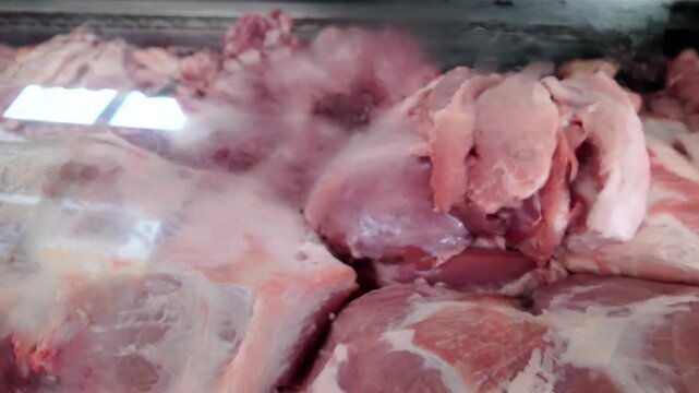raw pork meat displayed in a butcher shop showcase
