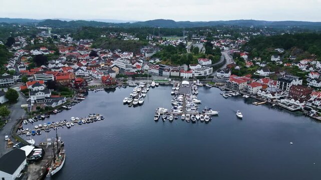 Aerial view of the harbour and town with boats docked at the marina in Grimstad, Agder, Norway.