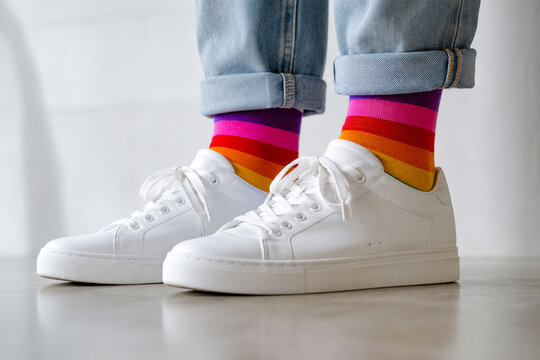 Rainbow Socks Peeking Above White Sneakers in Minimalist Casual Fashion Concept