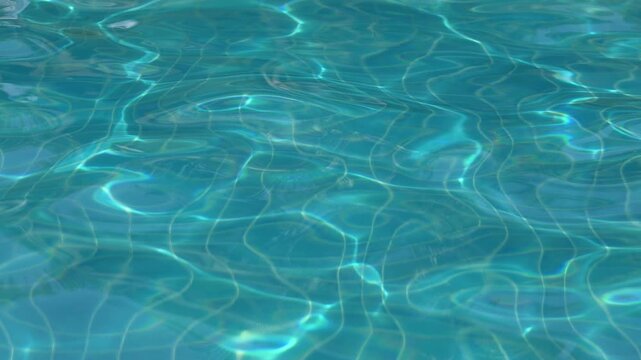 Ripple water surface and sun reflection in swimming pool	