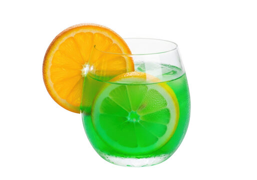 Glass of green cocktail with orange and lemon slices isolated on transparent background