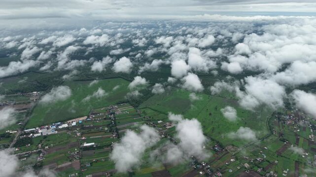 Aerial view of lush green agricultural fields and scattered rural settlements under a cloudy sky in Haldwani, Uttarakhand, India.