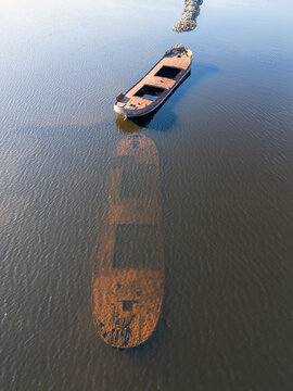 Aerial view of the shipwreck at Pateniemenranta, showing the vessel and its submerged outline in the calm water of Oulu, Pohjois-Pohjanmaa, Finland.