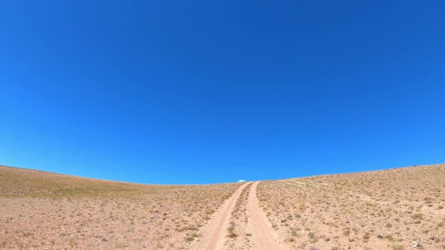 Driving along a country road in Altai desert and semi-desert environment.