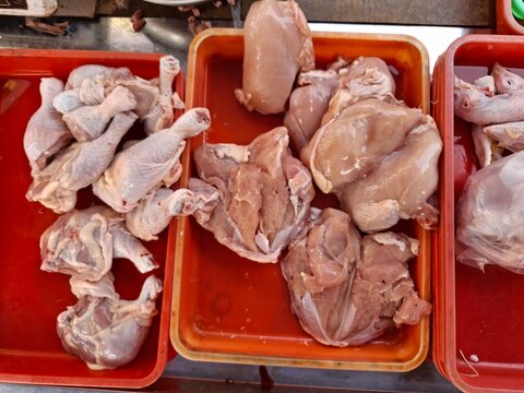 Piles of broiler chickens at a traditional market.