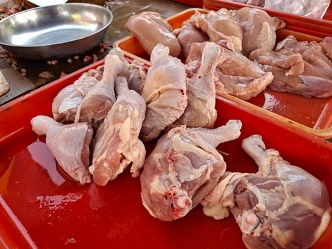 Piles of broiler chickens at a traditional market.