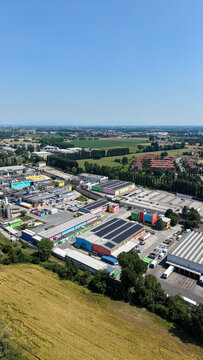 Aerial view of a pharmaceutical industrial cluster in Milan, Lombardy, Italy showing modern production facilities, research infrastructure, and healthcare industry development.