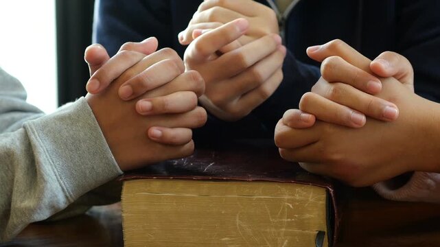 Group of people praying. Christian worship and pray. Christian group of people holding hands praying worships together to believe