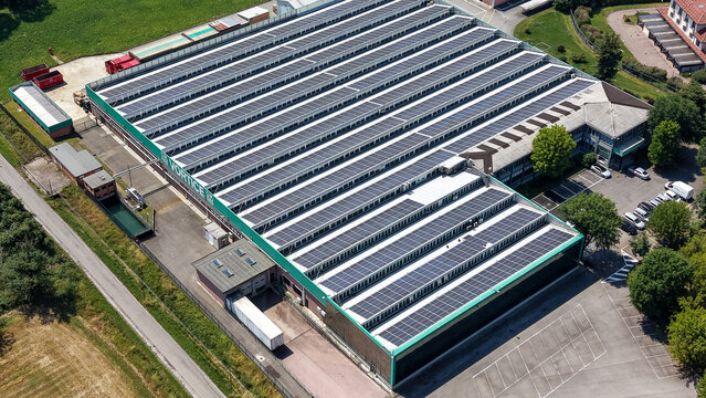 Milan, Lombardy, Italy - 19 June 2026: Aerial view of the Vortice HVAC facility, featuring extensive rooftop solar panels, industrial ventilation systems, and surrounding parking areas.
