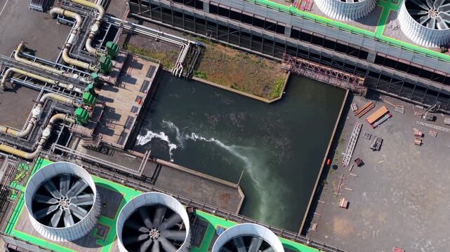 Aerial view of VPI Immingham power plant showing large industrial cooling fans and water intake infrastructure in South Killingholme, England, United Kingdom.