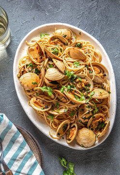 Seafood Italian Pasta. Spaghetti with vongole. Clams spaghetti on white plate with white wine