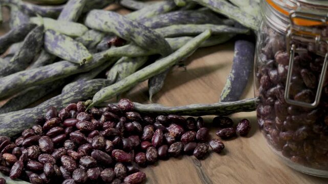 Pinto beans on wooden table with green beans panning handheld camera, 4K