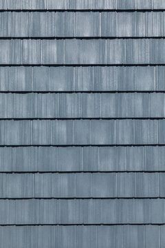 detail of rectangular light blue painted wooden shingles