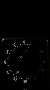 Time lapse of a kitchen clock timer countdown to zero.