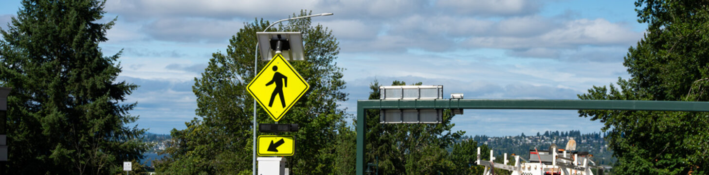 Solar powered temporary crosswalk electronic sign, major road infrastructure summer construction project
