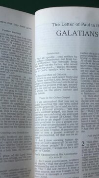 Opening to the book of Galatians of the New Testament in the Holy Bible. New Revised Standard Version. Vertical video.