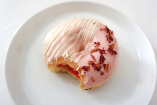 bite donut soft pink glazed edible flower decoration