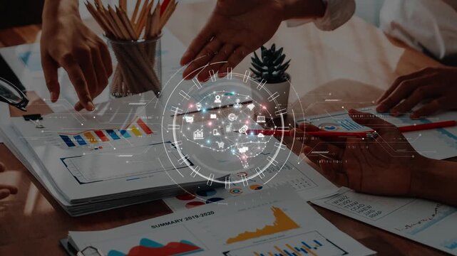 A diverse team collaborates over charts and digital icons, analyzing data and fostering innovation in a modern office setup for strategic business decisions. Raster