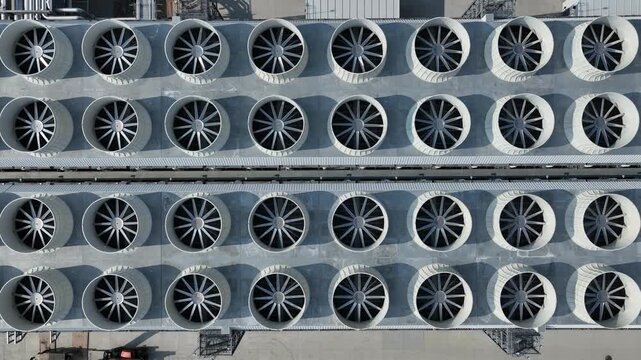 Top-down flyover of industrial cooling fans at a hyperscale AI data center showing large rooftop cooling infrastructure supporting cloud computing operations.