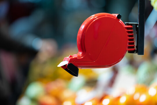 Red Queue Ticket Dispenser in a Retail Store