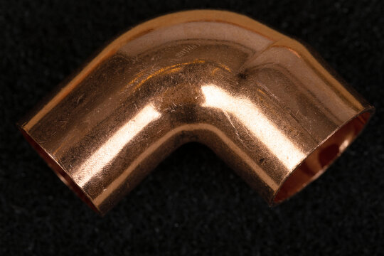 Copper 90 Degree Elbow Pipe Fitting on Black Background