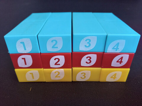 Colorful numbered plastic toy blocks stacked in order.