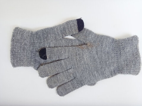 Pair of stacked gray knitted gloves on a white background.