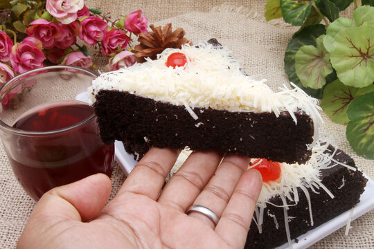 brownies cake with grated cheese on hand