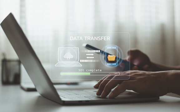 Business professional using laptop with data transfer interface, digital file sharing, cloud computing, mobile connectivity, online storage, network communication, synchronization, modern technology.