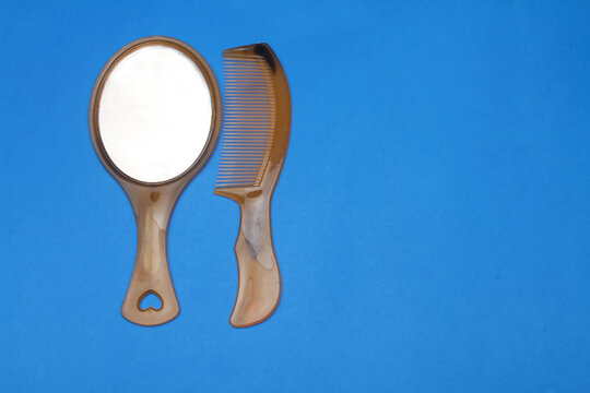 comb and mirror on blue backgrond