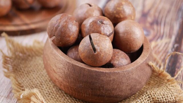 Macadamia Nuts in a Wooden Bowl on a Rustic Table