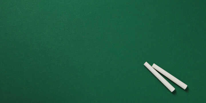 Back to school, Chalk pieces rest on green board ready for new school year