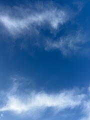 Fototapeta premium Blue sky fluffy white clouds vertical air background