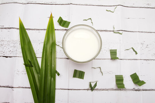 a glass of milk on white table