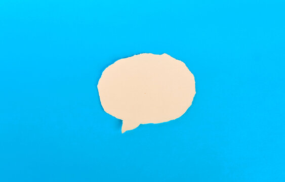 Blank pale yellow paper speech bubble centered on bright blue background

