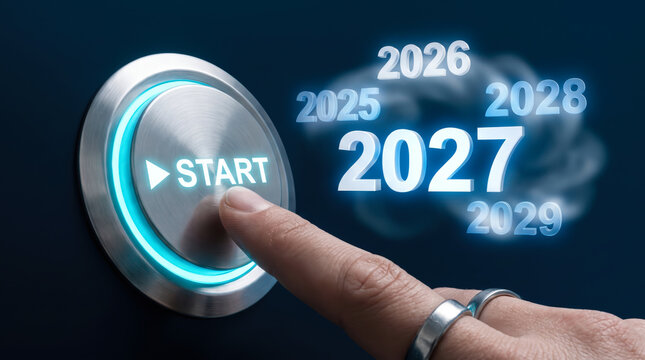Finger pressing a glowing start button to initiate the year 2027 concept
