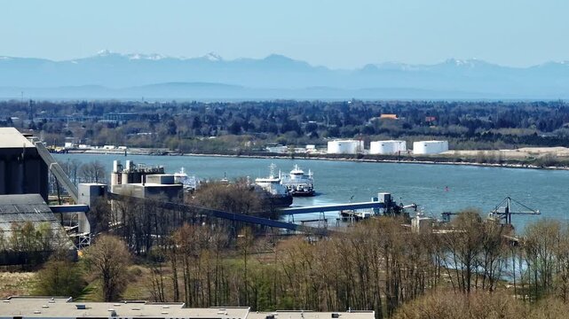 A Scenic View of Seaspan Shipping Operations and the Commercial Industrial Ferry Terminal Along the Fraser River in Delta, Richmond, British Columbia, Canada - Orbit Drone Shot