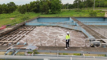 Fototapeta premium Drone aerial perspective of water treatment facility and industrial wastewater management basin. Environmental engineering, sanitation infrastructure and recycling process.