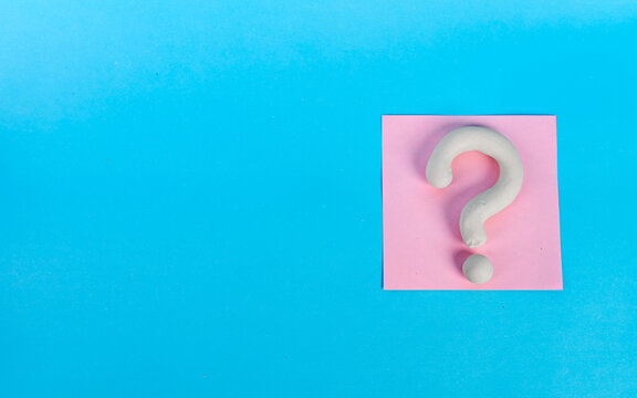 White 3D question mark on a single pink note with copy space on blue background
