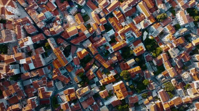 Top-down drone view of Split Old Town rooftops and narrow streets at sunrise, Croatia